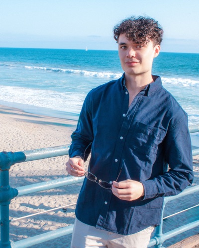 Alex on a pier above the beach